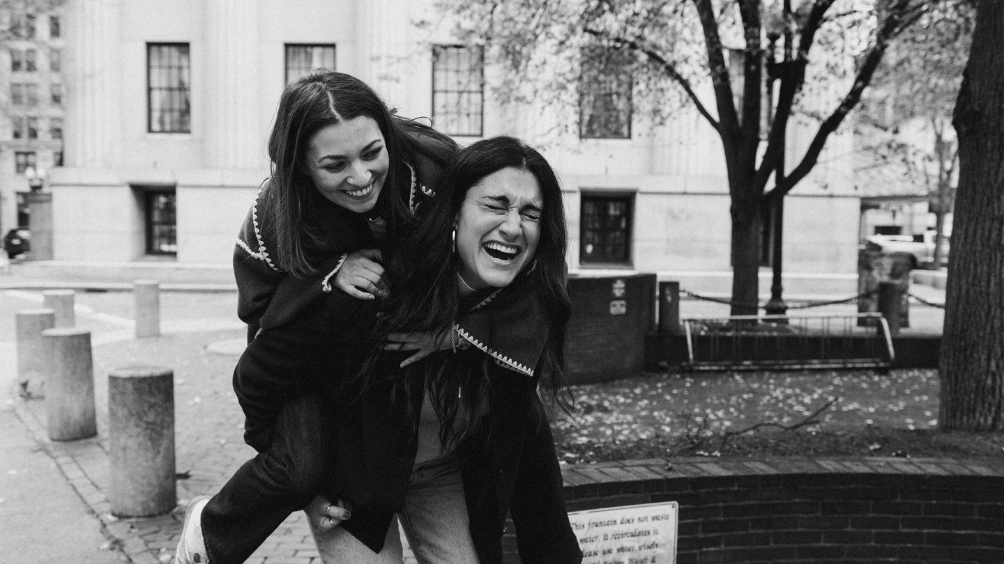 two woman laughing together